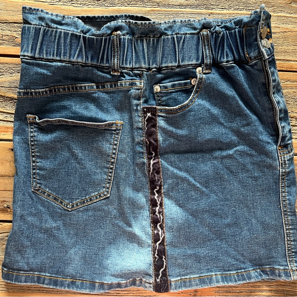 Cute jean skirt with a fun, rugged, velvety ribbon on each side.